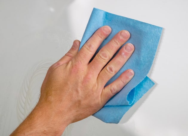 Once the scratch is removed, use water and paper towels to clean the glass